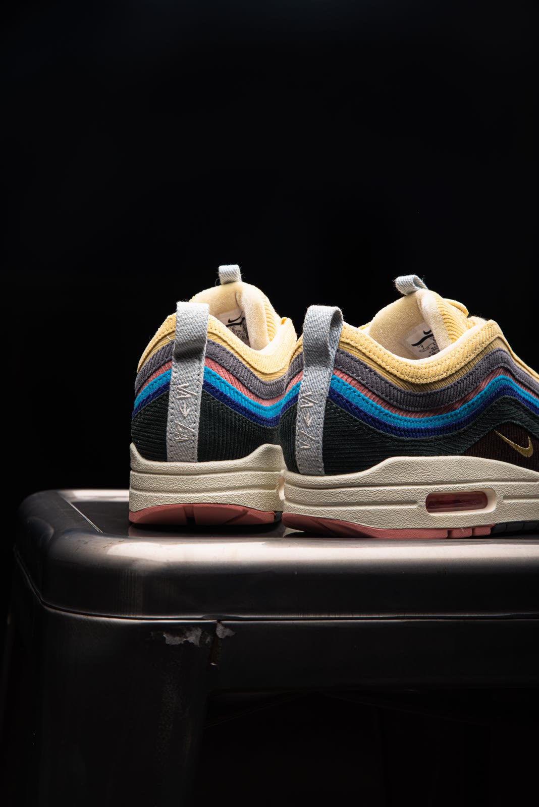 Colourful sneakers arranged in a studio composition.