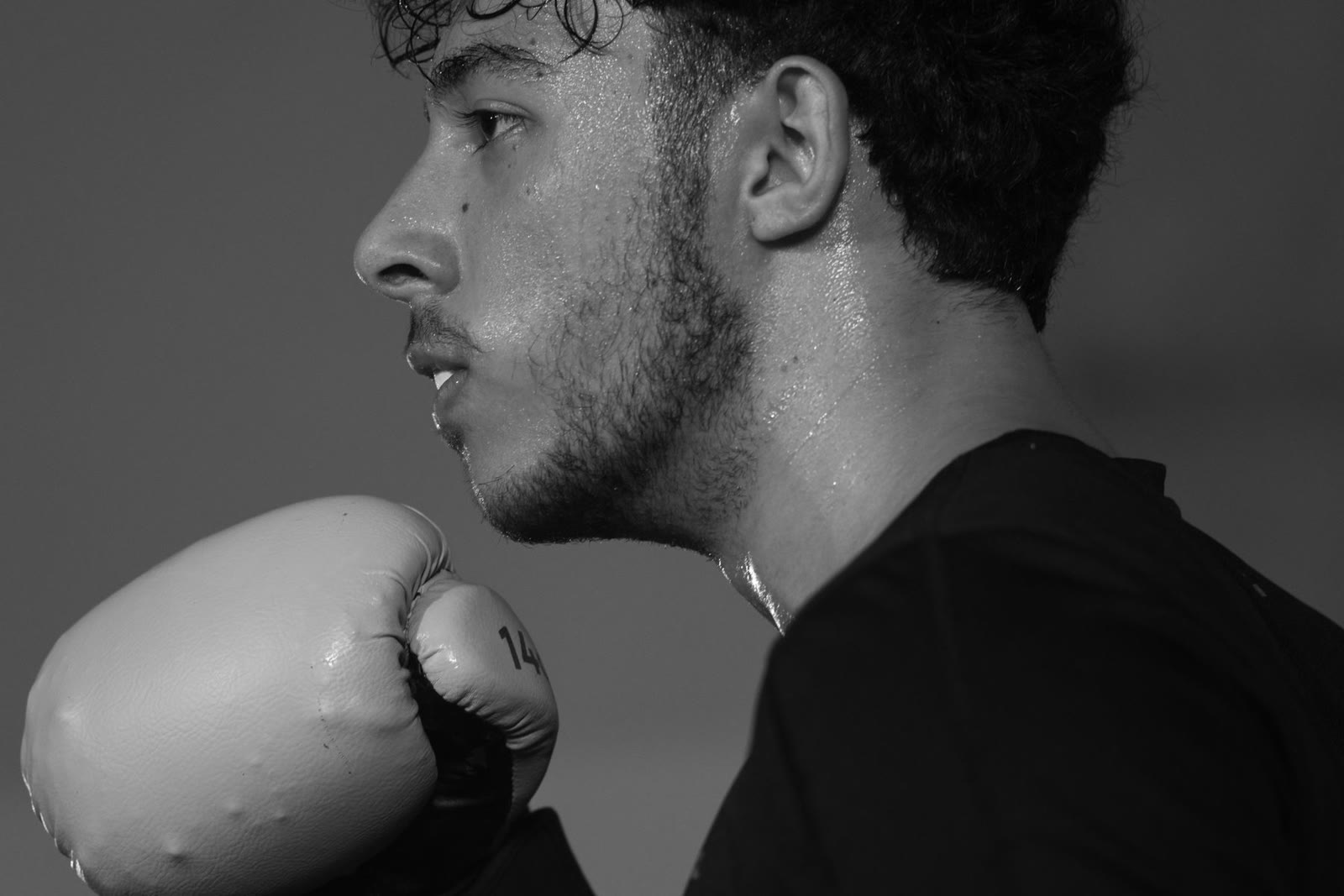 A focused boxer training in black and white.